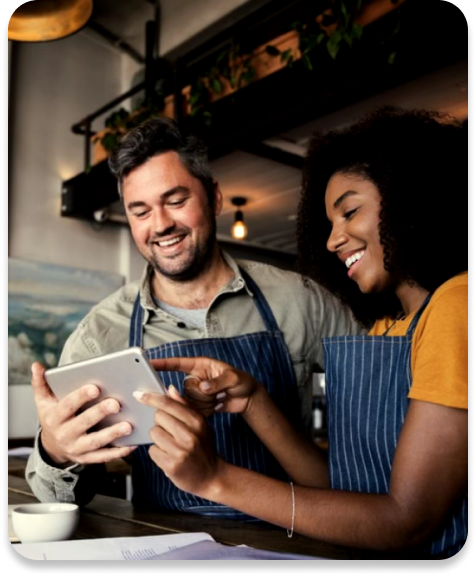 Two coworkers holding a tablet